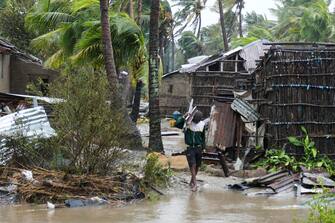 epa10517496 A man collects some wood on a flooded street near Quelimane, as the storm Freddy hits Mozambique, 12 March 2023. The provincial capital of Quelimane will be the largest urban area closest to the cyclone's point of arrival on the mainland, and its radius (of about 300 kilometres) is expected to extend from Marromeu to Pebane, then moving inland towards Cherimane and southern Malawi. This is one of the longest lasting storms ever, after it formed at the beginning of February in the Asian seas, crossing the entire Indian Ocean to the east African coast.  EPA/ANDRE CATUEIRA