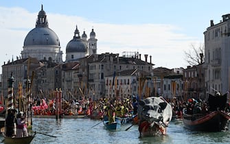 Decorated boats sail on the Grand Canal during Venice Carnival, on February 16, 2025. This year, the theme of one of the most famous carnival in the world is Casanova, as the 'Serenissima' celebrates the 300th anniversary of the famous man's birth. (Photo by ANDREA PATTARO / AFP)