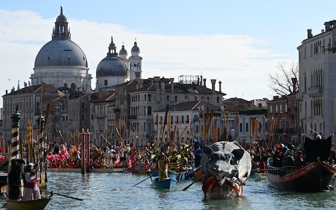 Decorated boats sail on the Grand Canal during Venice Carnival, on February 16, 2025. This year, the theme of one of the most famous carnival in the world is Casanova, as the 'Serenissima' celebrates the 300th anniversary of the famous man's birth. (Photo by ANDREA PATTARO / AFP)