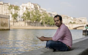 Taha Siddiqui, award-winning Pakistani journalist, poses for a photograph on the bank of the River Seine in Paris, France, on Sunday, July 8, 2018.. Siddiqui fled to France with his family after surviving an attempted armed abduction on a busy highway in Islamabad. Photographer: Marlene Awaad/Bloomberg via Getty Images