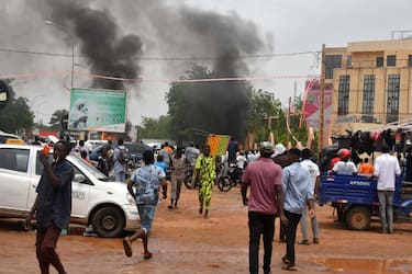 A general view of billowing smoke as supporters of the Nigerien defence and security forces attack the headquarters of the Nigerien Party for Democracy and Socialism (PNDS), the party of overthrown President Mohamed Bazoum, in Niamey on July 27, 2023. The head of Niger's armed forces on July 27, 2023 said he endorsed a declaration by troops who overnight announced they had taken power after detaining the country's elected president, Mohamed Bazoum.
"The military command of the Nigerien armed forces... has decided to subscribe to the declaration by the defence and security forces... in order to avoid a deadly confrontation between the various forces," said a statement signed by armed forces chief General Abdou Sidikou Issa. (Photo by AFP)