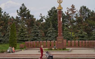 CHISINAU, MOLDOVA - May 03: A woman with a child walks past Soviet-era monument, part of Eternity Memorial Complex, in the memory of the Soviet soldiers who died in WWII, on May 3, 2022 in Chisinau, Moldova. More than two months into the Russian invasion of Ukraine, fears of the conflict spilling over into Moldova, a country of 2.5 million inhabitants, has increased after two attacks on April 23 and 24 in the separatist region of Transnistria. Since then, rumors have fueled divisions, and some Moldovans are preparing to leave the country. (Photo by Andreea Campeanu/Getty Images)