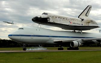 epa03185974 The Discovery space shuttle arrives, mated with a Boeing 747 carrier aircraft, at Washington Dulles International Airport in Chantilly, Virginia, USA, 17 April 2012. NASA and Smithsonian officials will officially transfer Discovery to the Steven F. Udvar-Hazy Center during a ceremony 19 April 2012. Discovery is the longest-serving orbiter in the space shuttle fleet.  EPA/MICHAEL REYNOLDS