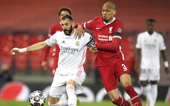 epa09927827 (FILE) - Real Madrid's Karim Benzema (L) in action against Liverpool's Fabinho (R) during the UEFA Champions League quarter final, second leg soccer match between Liverpool FC and Real Madrid in Liverpool, Britain, 14 April 2021 (re-issued on 05 May 2022). Liverpool FC will face Real Madrid in the UEFA Champions League final on 28 May 2022 at Stade de France in Saint-Denis, near Paris, France.  EPA/Peter Powell