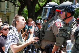 epa11309330 A student yells at Texas State Troopers during a Protect Palestine Rally on the University of Texas at Austin campus in Austin, Texas, USA, 29 April 2024. Campus police officers from the University of Texas at Austin and state troopers in riot gear arrested dozens of pro-Palestinian protesters who had erected a small number of tents on a central mall of the university. More than 34,000 Palestinians and over 1,450 Israelis have been killed, according to the Palestinian Health Ministry and the Israel Defense Forces (IDF), since Hamas militants launched an attack against Israel from the Gaza Strip on 07 October 2023, and the Israeli operations in Gaza and the West Bank which followed it.  EPA/ADAM DAVIS