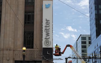 epa10766833 A worker removes letters from the iconic vertical Twitter sign at the company’s headquarters after Twitter owner Elon Musk annouced the rebranding of the social media platorm to X in San Francisco, California, USA, 24 July 2023. Work was halted due to San Francisco police responding to a call from building security that the signs were being stolen. A San Francisco police spokesperson stated that Twitter had a work order to take the sign down but didn’t communicate that to security and the property owner of the building.  EPA/JOHN G. MABANGLO