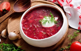 borscht Borscht soup in white bowl with sour cream. National Ukrainian and Russian cuisine food. Closeup view