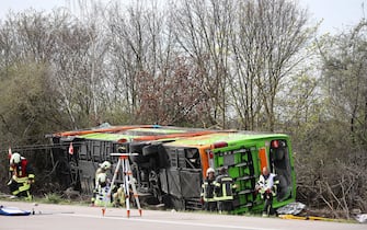 27 March 2024, Saxony, Schkeuditz: A coach lies overturned on its side at the scene of an accident on the A9. At least five people have died in an accident involving a coach on the A9 near Leipzig. This was announced by the police on request. There were also numerous injuries in the accident on Wednesday. Photo: Jan Woitas/dpa (Photo by Jan Woitas/picture alliance via Getty Images)