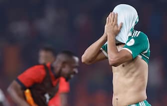 Algeria's forward #9 Baghdad Bounedjah reacts after Mauritania won the Africa Cup of Nations (CAN) 2024 group D football match between Mauritania and Algeria at Stade de la Paix in Bouake on January 23, 2024. (Photo by KENZO TRIBOUILLARD / AFP)