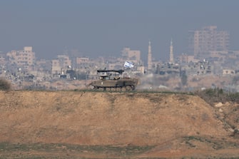epa11049138 An armored vehicle of the Israeli army patrols an area overlooking the Shujaiya neighborhood in the Gaza Strip, near the Israeli-Gaza border in southern Israel, 30 December 2023. More than 21,000 Palestinians and at least 1,300 Israelis have been killed, according to the Palestinian Health Ministry and the Israel Defense Forces (IDF), since Hamas militants launched an attack against Israel from the Gaza Strip on 07 October, and the Israeli operations in Gaza and the West Bank which followed it. The Israeli military stated that its ground, air, and naval troops are 'continuing to strike' targets in the Gaza Strip.  EPA/ATEF SAFADI