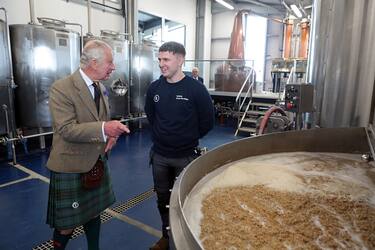 WICK, SCOTLAND - AUGUST 2: King Charles III, with distillery manager Ryan Sutherland, during a visit to the 8 Doors Distillery in John O'Groats, Wick, in the Scottish Highlands, to officially open the distillery and meet members of the local business community on August 2, 2023 in Wick, Scotland. (Photo by Robert MacDonald - Pool/Getty Images)