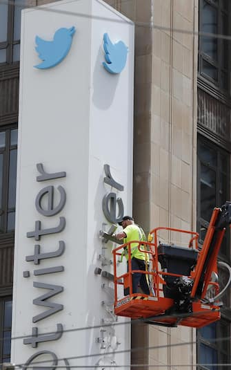epa10766818 Workers remove letters from the iconic vertical Twitter sign at the company’s headquarters after Twitter owner Elon Musk annouced the rebranding of the social media platorm to X in San Francisco, California, USA, 24 July 2023. Work was halted due to San Francisco police responding to a call from building security that the signs were being stolen. A San Francisco police spokesperson stated that Twitter had a work order to take the sign down but didn’t communicate that to security and the property owner of the building.  EPA/JOHN G. MABANGLO