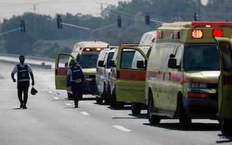 epa10906101 Israeli ambulance cars wait to evacuatec wounded residents from the city of Sderot, 07 October 2023, after rocket barrages were launched from the Gaza Strip early Saturday in a surprise attack claimed by the Islamist movement Hamas. Israeli State reports that at least 22 Israelis were killed in seven active combat centers in the South, and that over 3,000 rockets were launched by Hamas.  EPA/ATEF SAFADI ATTENTION EDITORS: GRAPHIC CONTENT