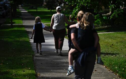 MINNEAPOLIS, MINNESOTA - AUGUST 27: Families depart Annunciation Catholic School following a mass shooting on August 27, 2025 in Minneapolis, Minnesota. According to Minneapolis Police, a gunman fired through the windows of the Annunciation Church at worshippers sitting in pews during a Catholic school Mass, killing two children and injuring at least 17 others. The gunman reportedly died at the scene from a self-inflicted gunshot wound. (Photo by Stephen Maturen/Getty Images)