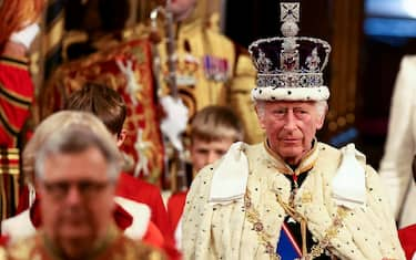 Britain's King Charles III, wearing the Imperial State Crown, processes through the Royal Gallery during the State Opening of Parliament at the Houses of Parliament, in London, on July 17, 2024. (Photo by Hannah McKay / POOL / AFP)