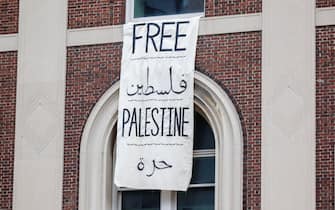 epa11310479 A 'Free Palestine' sign hangs from a window following pro-Palestine students' takeover of Hamilton Hall, on Columbia University's campus in New York, New York, USA, 30 April 2024. Columbia University shut down its campus on 30 April in response. Students have been protesting the university's investments in Israel and showing their support for Palestine for over two weeks, also inspiring other students nationwide to do the same.  EPA/SARAH YENESEL