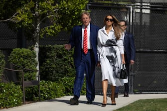 PALM BEACH, FLORIDA - MARCH 19:  Former U.S. President Donald Trump and former first lady Melania Trump walk together as they prepare to vote at a polling station setup in the Morton and Barbara Mandel Recreation Center on March 19, 2024, in Palm Beach, Florida.  Trump, along with other registered Republican voters, cast ballots in the Presidential Preference Primary. There wasn't a ballot or election for Democrats since the Florida Democratic Party only provided the name of Joseph R. Biden Jr. (Photo by Joe Raedle/Getty Images)