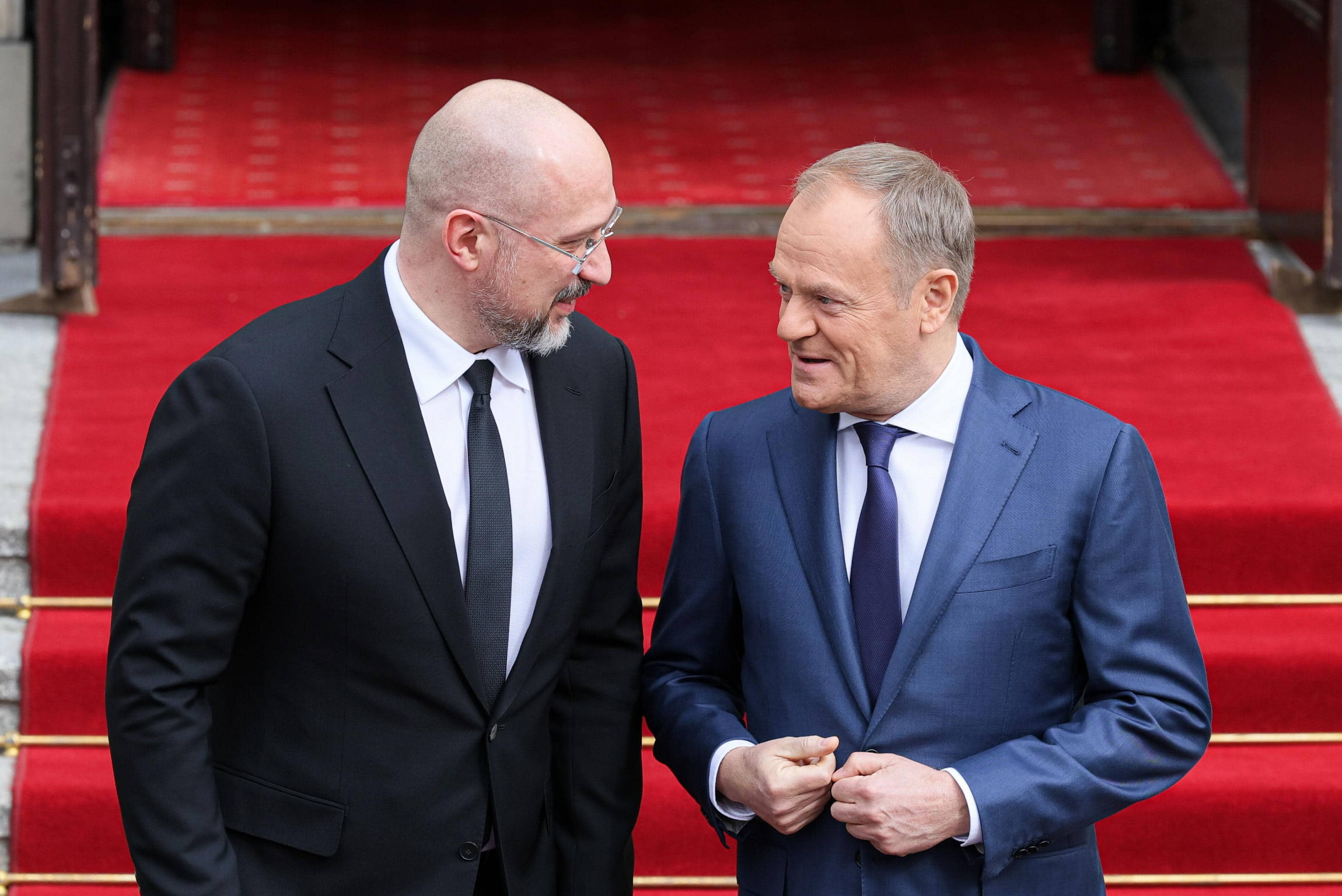 epa11247929 Polish Prime Minister Donald Tusk (R) welcomes Ukrainian Prime Minister Denys Shmyhal (L) before their meeting at the Prime Minister's Office in Warsaw, Poland, 28 March 2024.  EPA/Pawel Supernak  POLAND OUT