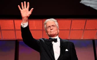 US actor Michael Douglas gestures on stage as he speaks after he received the Honorary Palme d'or of he 76th Cannes Film Festival during the opening ceremony in Cannes, southern France, on May 16, 2023. (Photo by Valery HACHE / AFP) (Photo by VALERY HACHE/AFP via Getty Images)