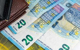 20 and 50 euro bills with currency symbol and wallet on the table