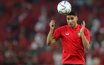 epa10359042 Achraf Hakimi of Morocco warms up prior to the FIFA World Cup 2022 quarter final soccer match between Morocco and Portugal at Al Thumama Stadium in Doha, Qatar, 10 December 2022.  EPA/Friedemann Vogel