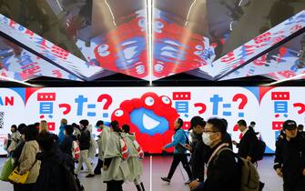 epa12028410 Visitors and staff members walk past the Expo mascott Myaku-Myaku at Yumashima station before the opening of Osaka Expo 2025 in Osaka, Japan, 13 April 2025. The Expo 2025 Osaka, Kansai, Japan will be opened to the public until 13 October 2025.  EPA/FRANCK ROBICHON