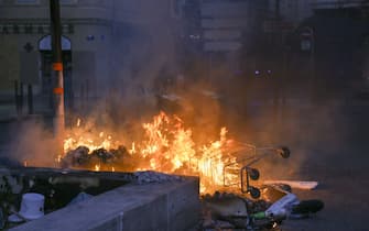 MARSEILLE, FRANCE - JULY 01: A view of a burning shopping cart next to the garbage as people gather to protest against the death of 17-year-old Nahel, who was shot in the chest by police in Nanterre on June 27, in Marseille, France on July 01, 2023. More than 600 people were arrested across France on Thursday as protests over the fatal police shooting of a 17-year-old continued for a third night. The protesters set fire to various buildings and vandalized public property, and a number of suburbs and towns in the Parisian region also imposed a curfew. (Photo by Naseer Turkmani/Anadolu Agency via Getty Images)