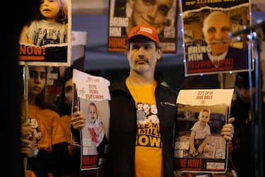 Relatives and supporters hold placards bearing portraits of Israeli hostages held in Gaza since the October 7 attacks by Hamas in southern Israel, during a rally calling for their release, in Tel Aviv on January 27, 2024. The placards (front) show Kfir Bibas and Ariel Bibas. (Photo by AHMAD GHARABLI / AFP)