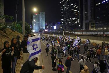 epa10530881 Protesters block the Ayalon main highway during a protest march against the government's justice system reform plans in Tel Aviv, Israel, 18 March 2023. Nationwide protests against the government's judicial reform plans are being held for eleven weeks in a row. Israel's parliament passed a draft law limiting the power of the Israeli Supreme Court in a first reading on 14 March.  EPA/ABIR SULTAN