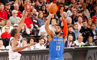 PORTLAND, OR - APRIL 14: Paul George #13 of the Oklahoma City Thunder shoots the ball during the game against Al-Farouq Aminu #8 of the Portland Trail Blazers during Game One of Round One of the 2019 NBA Playoffs on April 14, 2019 at the Moda Center Arena in Portland, Oregon. NOTE TO USER: User expressly acknowledges and agrees that, by downloading and or using this photograph, user is consenting to the terms and conditions of the Getty Images License Agreement. Mandatory Copyright Notice: Copyright 2019 NBAE (Photo by Cameron Browne/NBAE via Getty Images)