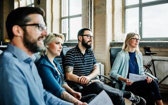 Colleagues listening during a casual business meeting in office loft