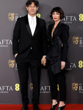 LONDON, ENGLAND - FEBRUARY 18: Jonathan Glazer and  Rachel Penfold attend the 2024 EE BAFTA Film Awards at The Royal Festival Hall on February 18, 2024 in London, England. (Photo by John Phillips/Getty Images)