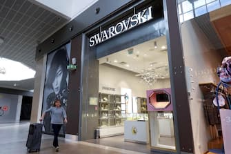 epa10513566 A woman walks past a Swarovski boutique at a mall, in Moscow, Russia, 10 March 2023. On 09 March 2023, Swarovski CEO Alexis Nasard announced the company's decision to leave the Russian market. Swarovski had suspended its operations in March 2022 due to the start of Russia's 'special operation' in Ukraine.  EPA/MAXIM SHIPENKOV