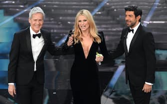 Italian singer and Sanremo Festival artistic director Claudio Baglioni (L), Swiss-Italian TV showgirl Michelle Hunziker (C) and Italian actor Pierfrancesco Favino (R) on stage during the 68th Sanremo Italian Song Festival at the Ariston theatre in Sanremo, Italy, 06 February 2018. The 68th edition of the television song contest runs from 06 to 10 February. ANSA/CLAUDIO ONORATI 
