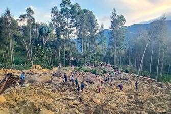 TOPSHOT - People gather at the site of a landslide in Maip Mulitaka in Papua New Guinea's Enga Province on May 24, 2024. Local officials and aid groups said a massive landslide struck a village in Papua New Guinea's highlands on May 24, with many feared dead. (Photo by AFP) (Photo by STR/AFP via Getty Images)