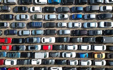 Overhead aerial view of various second hand cars neatly parked at a car auction