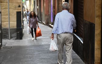 Anziani con le borse della spesa, in giro per la citta'. Genova, 01 agosto 2019.
ANSA/LUCA ZENNARO