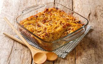 yerushalmi kugel a traditional eastern European Jewish food made of noodles and burnt sugar close-up in a glass bowl on the table. Horizontal