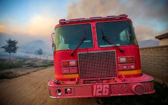 Los Angeles Castaic, CA - APRIL 28: Pretty in pink. A firetruck is covered with pink fire retardant called Phos-Chek. A fire in the Castaic and Valencia area quickly spread to at least 650 acres, triggering mandatory evacuation orders and road closures in the area on Wednesday, April 28, 2021 in Castaic CA. (Francine Orr / Los Angeles Times)