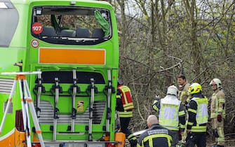 Emergency personnel works on a damaged bus on the A9 highway, at the scene of an accident where at least five people were killed, on March 27, 2024 in Schkeuditz, near Leipzig, eastern Germany. (Photo by Jens Schlueter / AFP) (Photo by JENS SCHLUETER/AFP via Getty Images)