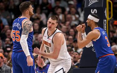 DENVER, CO - MARCH 21: Nikola Jokic (15) of the Denver Nuggets gives a casual reaction to bullying his way through Isaiah Hartenstein (55) and Josh Hart (3) of the New York Knicks en route to scoring during the fourth quarter of the Nuggets' 113-100 win at Ball Arena in Denver on Thursday, March 21, 2024. (Photo by AAron Ontiveroz/The Denver Post)
