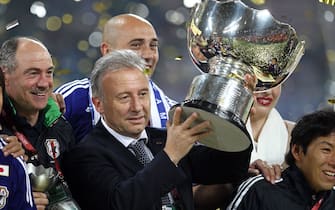 epa02555847 Japan's head coach Alberto Zaccheroni celebrates with the Asian Cup trophy after the AFC Asian Cup Qatar 2011 final soccer match between Australia and Japan at Khalifa International Stadium in Doha, Qatar, 29 January 2011. Japan won 1-0 after extra time.  EPA/MOHAMED FARAG