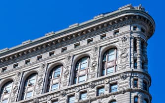 Close view of ornament on the building exterior of Flatiron Building in New York City. The Flatiron Building, originally the Fuller Building, is a steel-framed landmarked building located at 175 Fifth Avenue in the Flatiron District neighborhood of borough of Manhattan, New York City.. (Photo by: Sergi Reboredo/VW Pics/Universal Images Group via Getty Images)