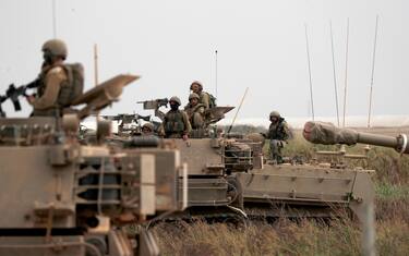 epa10909334 Israeli soldiers on military vehicles maneuver at an area along the border with Gaza, southern Israel, 09 October 2023. The Israeli army announced on 09 October, it carried out over 500 strikes on targets across the Gaza Strip overnight. Palestinian officials said almost 500 people were killed, including 91 children, and over 2,700 were injured after Israel launched retaliatory raids and air strikes in the Palestinian enclave. An unprecedented attack on southern Israel on 07 October claimed by the Islamist movement Hamas killed more than 700 Israelis and left over 2,150 injured, the Israeli army said.  EPA/ATEF SAFADI