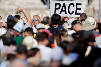 Faithful show a banner  with "Peace" during the Angelus prayer in St. Peter's Square, Vatican City, 08 October 2023. ANSA/VINCENZO LIVIERI