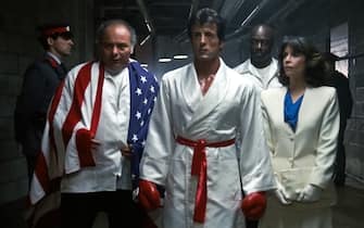 USA. Sylvester Stallone, Talia Shire, Tony Burton, and Burt Young in a scene from (C)MGM/UA film: Rocky IV (1985).
Plot: Rocky Balboa proudly holds the world heavyweight boxing championship, but a new challenger has stepped forward: Drago, a six-foot-four, 261-pound fighter who has the backing of the Soviet Union. 
Ref:  LMK110-J7060-260421
Supplied by LMKMEDIA. Editorial Only.
Landmark Media is not the copyright owner of these Film or TV stills but provides a service only for recognised Media outlets. pictures@lmkmedia.com