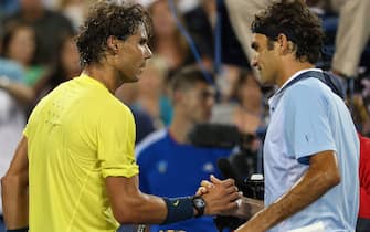 CINCINNATI, OH - AUGUST 16:  (L-R) Rafael Nadal of Spain shakes hands at the net with Roger Federer of Switzerland after their Men's Singles quarterfinals match during the Western & Southern Open on August 16, 2013 at Lindner Family Tennis Center in Cincinnati, Ohio.  (Photo by Ronald Martinez/Getty Images)