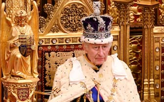 (FILES) Britain's King Charles III, wearing the Imperial State Crown and the Robe of State, sits on The Sovereign's Throne in the House of Lords chamber, during the State Opening of Parliament, at the Houses of Parliament, in London, on November 7, 2023. Britain's King Charles III has been diagnosed with a "form of cancer" according to a statement released by Buckingham Palace on February 5, 2024. (Photo by Leon Neal / POOL / AFP)