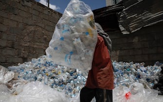 epa10671374 A worker sorts plastic items for recycling at a junkyard in Sana'a, Yemen, 03 June 2023. Over 1,400 tons of waste are collected daily from the streets of Sana'a with over five million people, according to statistics by the local cleanup service in the Yemeni capital. More poor people collect plastic materials from the streets and waste dumps across the major cities of Yemen, then sell them to junkyards where being sorted. The yard owners sell the plastic sorted materials to factories for recycling. The collectors of recyclables often earn between 1000 and 1500 Yemeni rial a day (between 1.92 and 2.88 euro). The World will mark the 2023 Environment Day on 05 June with a focus on 'solutions to plastic pollution.'  EPA/YAHYA ARHAB