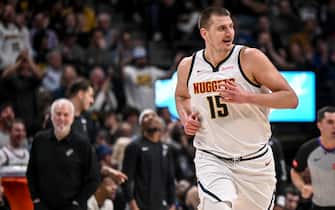 DENVER, CO - APRIL 2: Nikola Jokic (15) of the Denver Nuggets smiles in the direction of Victor Wembanyama (1) of the San Antonio Spurs after dunking on him during the first quarter at Ball Arena in Denver on Tuesday, April 2, 2024. (Photo by AAron Ontiveroz/The Denver Post)